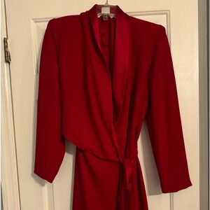 Red dress withh long sleeves and wrap on waistt.